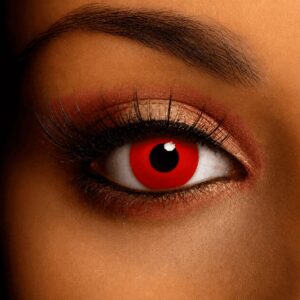 Close-up of a human eye wearing vivid blood red contact lenses with a dark black pupil.