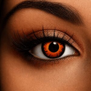 Close-up of an eye wearing Twilight Bella Contact Lenses, featuring a vibrant orange iris with bold black jagged detailing for a striking werewolf-inspired look.