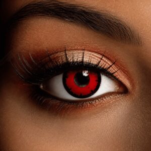 Close-up of an eye wearing Dead Red contact lenses with a vivid blood-red iris, black jagged outer ring and dark pupil.